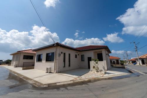 a small white house on the side of a street at Miyako Island Breeze in Miyako-jima