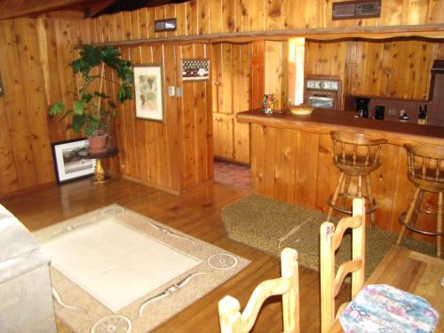 uma sala de estar com paredes de madeira e um bar em Kern Riverfront Lodge em Kernville