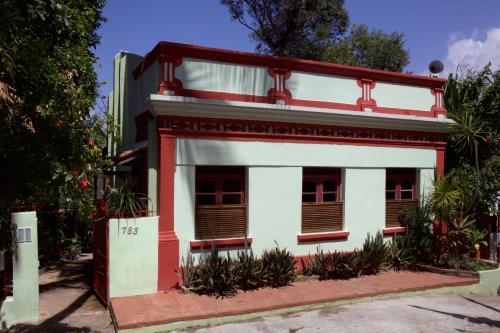 a white and red house with a red trim at Pousada Irradiante in Olinda