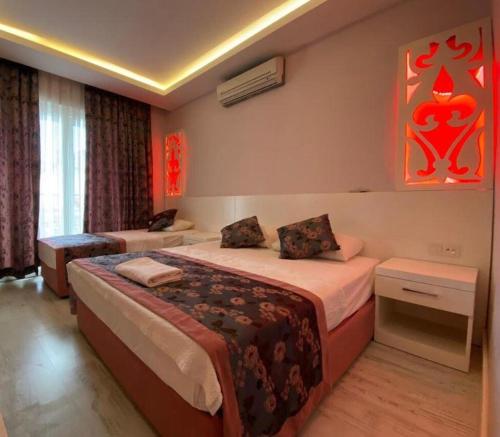 a bedroom with two beds in a room at Beachway Hotel in Side