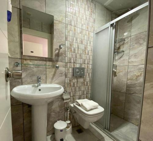 a bathroom with a sink and a toilet and a shower at Beachway Hotel in Side