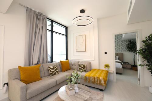 a living room with a couch and a table at Premium 1BR on Al Maryah Island, near ADGM in Abu Dhabi