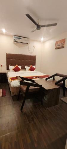 a room with a bed and a table in it at HOTEL classic in Visakhapatnam