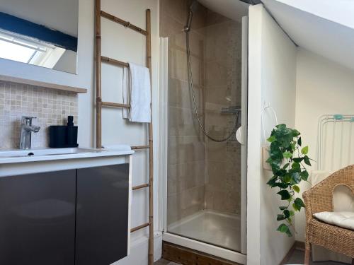 a bathroom with a shower with a glass door at Sur les Toits de Honfleur in Honfleur
