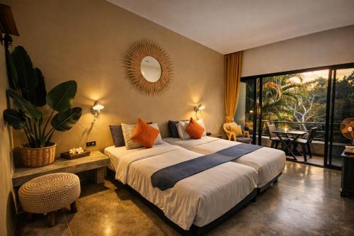 a bedroom with a large bed and a balcony at cooldowns resort maerim chiangmai in Ban Thung Pong