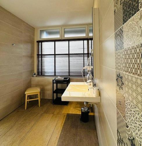 a bathroom with a sink and a window at Hotel Ajoncs d'Or in Saint Malo