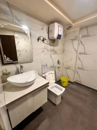 a bathroom with a sink and a toilet at Taj Castle Homestay in Agra