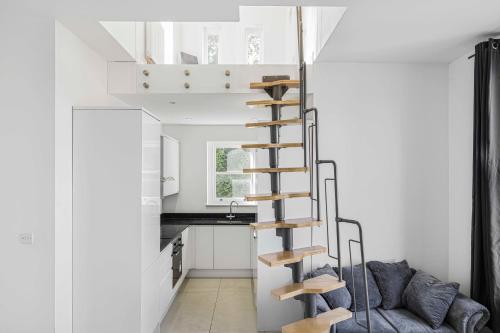 a room with a spiral staircase in a tiny house at Private Luxury Ensuite Room Greater London, Free Parking Gatwick 15MIN in Croydon
