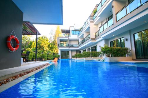 a swimming pool in front of a building at Chalay Monta in Hua Hin