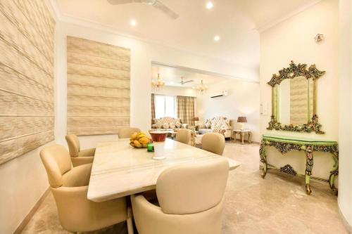 a dining room with a table and chairs at Palm 34 in Jaipur