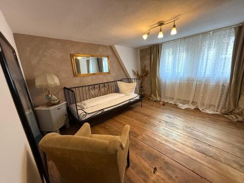 a living room with a couch and a mirror at Appartement Rothenburg in Rothenburg ob der Tauber