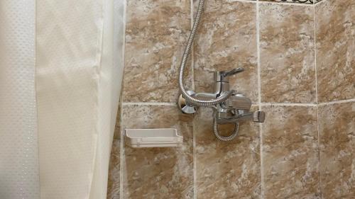 a shower in a bathroom with a shower head at Апартаменты 3а in Aktau