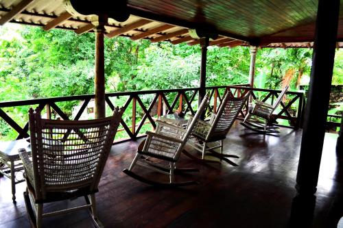 a group of chairs sitting on a porch at Laguna Beach Club in La Laguna