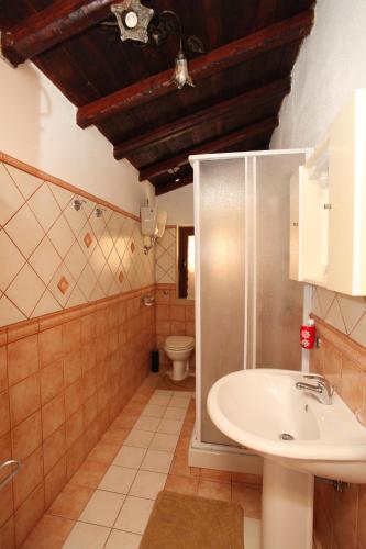 a bathroom with a sink and a toilet at Villa Salvatore in San Leone