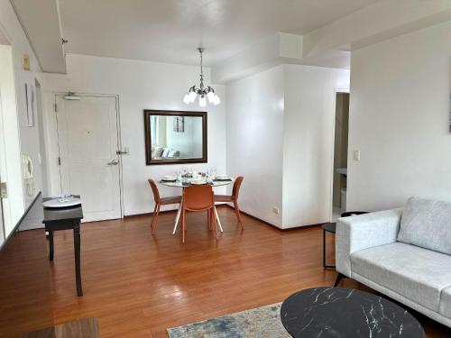 a living room with a table and a couch at Grand Cenia Residences in Cebu City