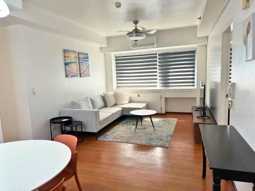 a living room with a couch and a table at Grand Cenia Residences in Cebu City
