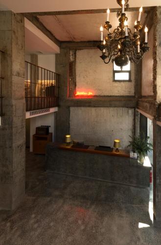 an empty room with a chandelier in a building at Zhuhai Bei Shan Ju Art Hotel in Zhuhai