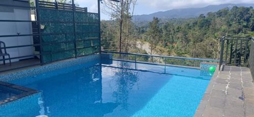 a swimming pool with a view of a mountain at Lazo EcoSpot Vythiri , Wayanad in Vythiri