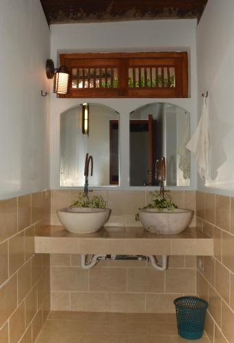 two sinks in a bathroom with a mirror at Laguna Beach Club in La Laguna