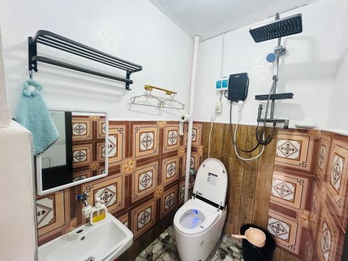 a bathroom with a toilet and a sink at Batad Pension Ph in Banaue