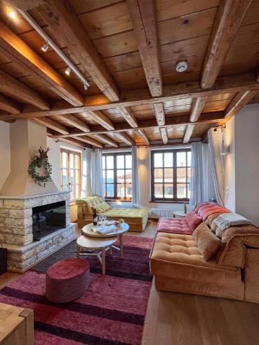 a living room with a couch and a fireplace at Meliades Luxury Villas in Arachova