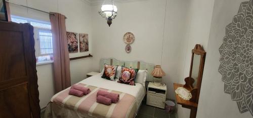 a bedroom with a bed with two pillows on it at Abi se Nessie in Orania