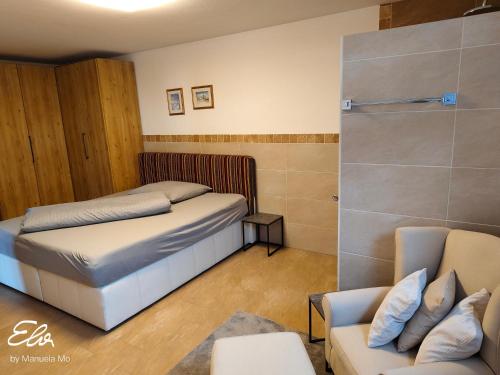 a small bedroom with a bed and a couch at Ferienwohnung Pusteblume4 in Oberau