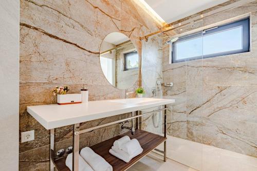 a bathroom with a sink and a mirror at Luxury Seafront Villa Miracul Korcula with Pool in Blato