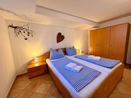 a bedroom with two beds with blue and white pillows at Ferienwohnung Bergpanorama Schönau in Schönau am Königssee