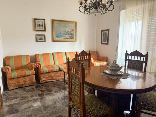 a living room with a table and a couch at Casa Vacanze da Francesco in Lettopalena