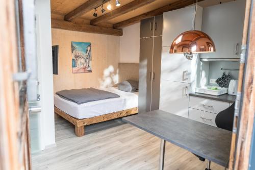 a small bedroom with a bed and a table at Il Giardino in Ilmmünster