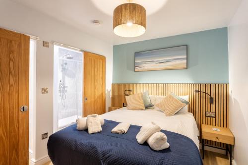 a bedroom with a large bed with towels on it at North Devon Resort One bedroom sea view hot tub Residence in Ilfracombe