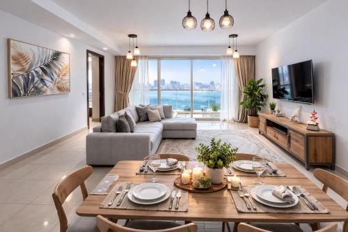 a living room with a table and a couch at Reem Island, Unique furnished one bedroom with amazing seaview in Abu Dhabi