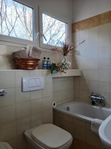a bathroom with a tub and a toilet and a window at como villa il panorama in Como
