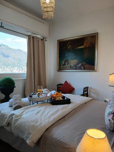 a bedroom with a bed with a tray of fruit on it at como villa il panorama in Como
