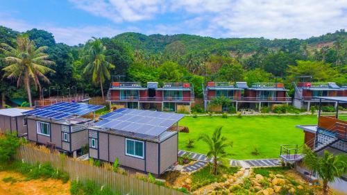 an aerial view of a house with solar panels on it at Baan Boom Boxes Eco Friendly Resort in Mae Nam