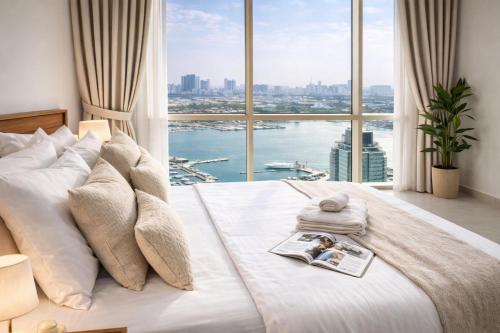 a bedroom with a large bed with a large window at Reem Island, Unique furnished one bedroom with amazing seaview in Abu Dhabi