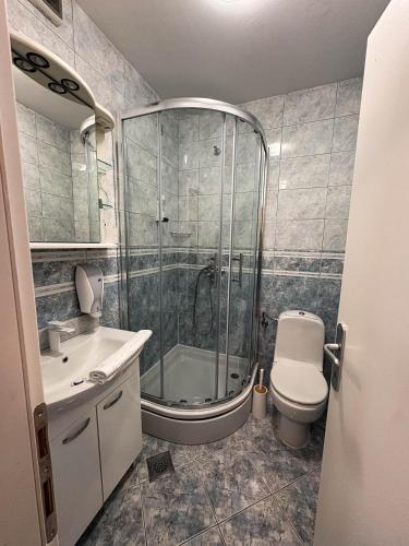 a bathroom with a shower and a toilet and a sink at Hotel Villa Neretva - Metković in Metković