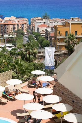 a group of tables and umbrellas on a balcony at Hotel Tropis in Tropea