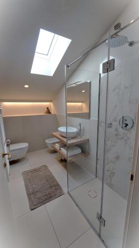 a bathroom with a shower and a toilet and a sink at SantAgata bed&breakfast in Como