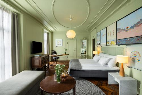 a living room with a bed and a couch at Grand Hotel Terminus in Bergen