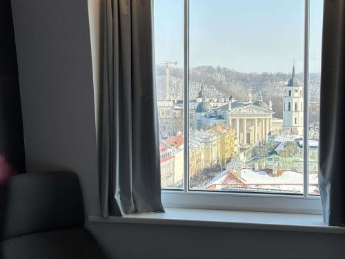 a window with a view of a city at Novotel Vilnius Centre in Vilnius