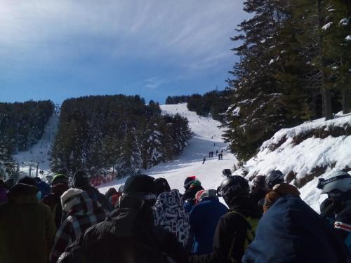 a crowd of people standing on a ski slope at Deny Holiday home in Dobrinishte