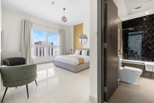 a hotel room with a bed and a bathroom at Unlock Metropolis Business Bay in Dubai
