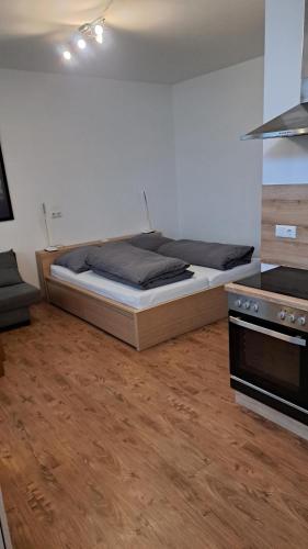 a bedroom with a bed and a stove at Monte Baldo in Ilmmünster