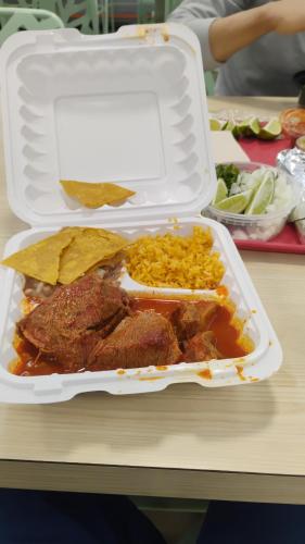 a styrofoam container of food with meat and rice at King city California in Mee Memorial Hospital Heliport