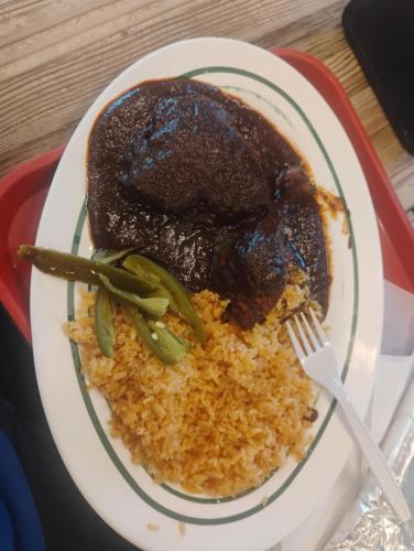 a plate of food with meat and rice with a fork at King city California in Mee Memorial Hospital Heliport
