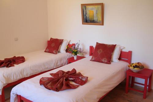 a room with two beds with scarves on them at Арт комплекс Горски дом - Трявна in Tryavna
