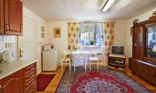 a kitchen with a table and a tv in it at Privát U Čejků in Telč