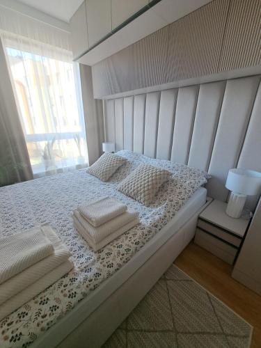 a bedroom with a white bed with two pillows at Classic&Modern Suite in Kętrzyn